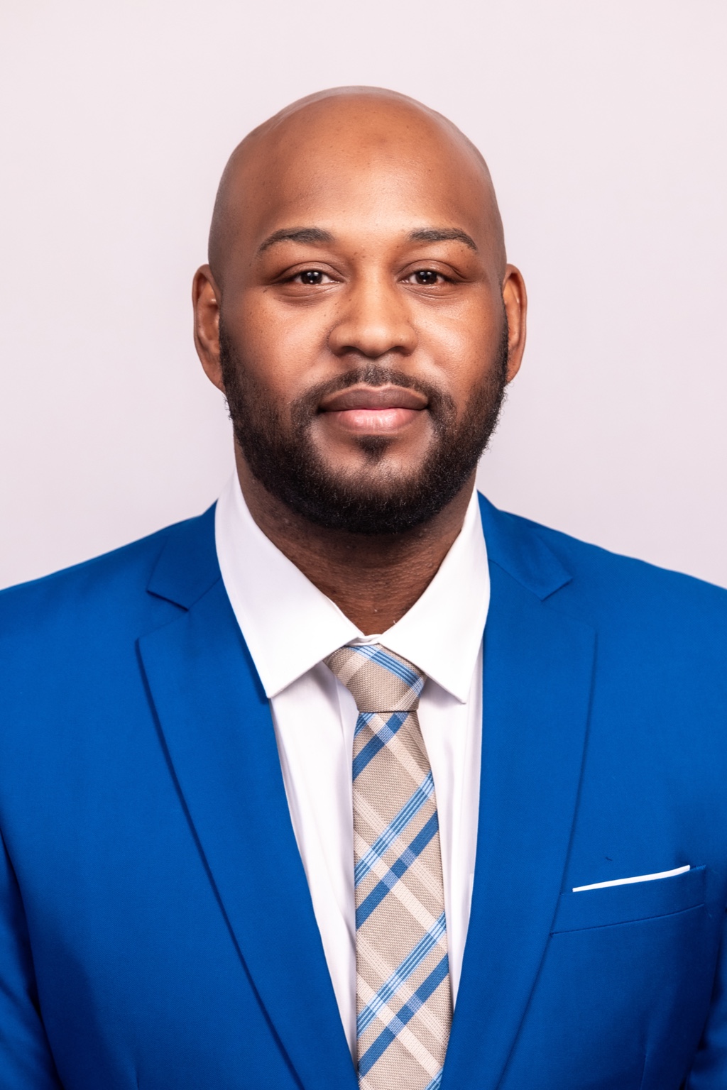Jermyn Brown professional headshot in blue suit